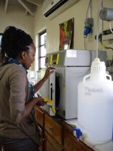 WASCO Laboratory worker with their benchtop Priorclave autoclave (WASCO, St. Lucia)